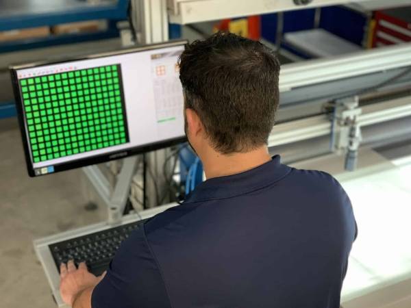 Workers are testing the surface of the mesh through computer.