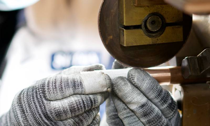 Workers carry out resistance welding.